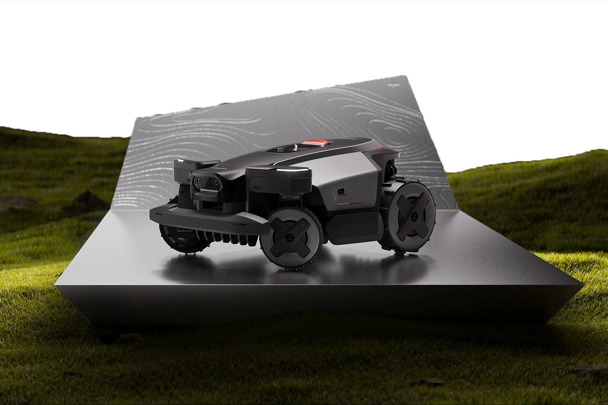 RockMow Z1 robotic lawn mower showing four-wheel drive terrain handling on a sloped garden surface
