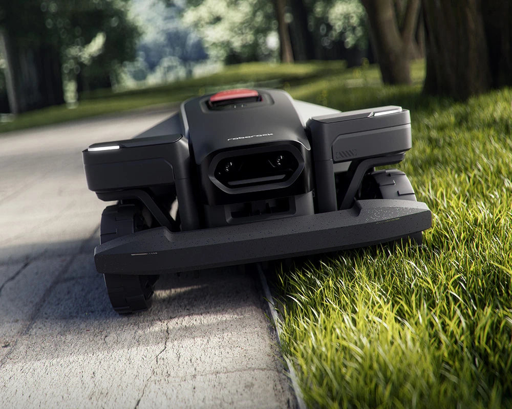 RockMow Z1 robotic lawn mower using a ride-on edge approach to cut closer along a paved boundary.