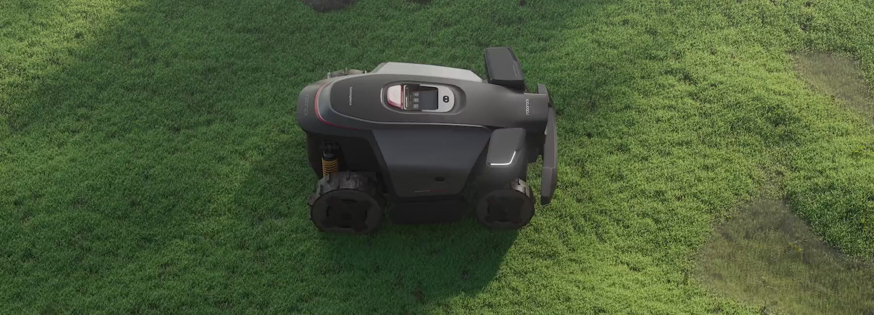 RockMow Z1 robotic lawn mower driving across rough and uneven terrain.