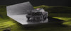 RockMow Z1 robotic lawn mower in a studio setting on a grass bank.